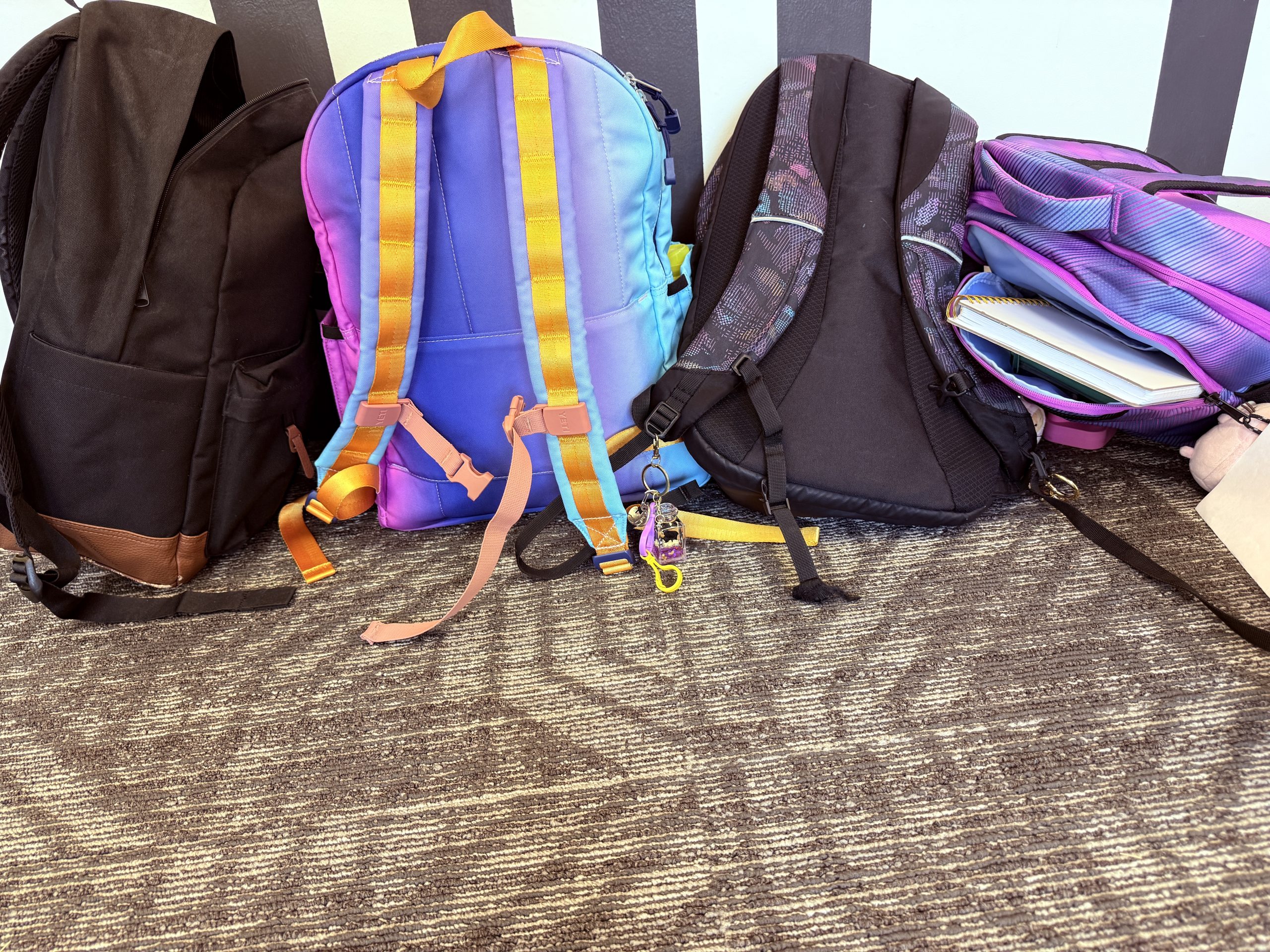 a row of colorful backbacks